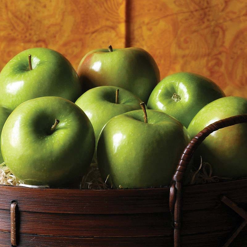 Fresh, tart Granny Smith apples for baking or snacking A bushel of bright green Granny Smith Apples